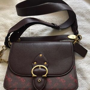 Elegant Brown Coach Leather Women's Bag with signature carriage pattern